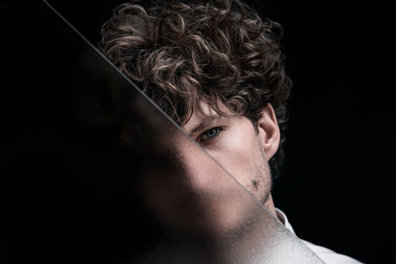 anonymous man standing behind glass