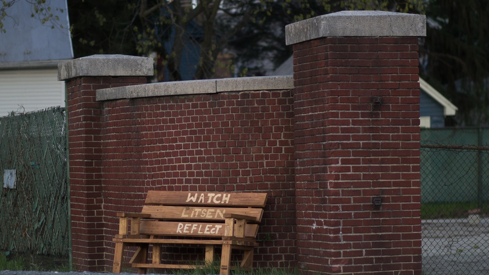 brown wooden bench beside brown wooden wall during daytime