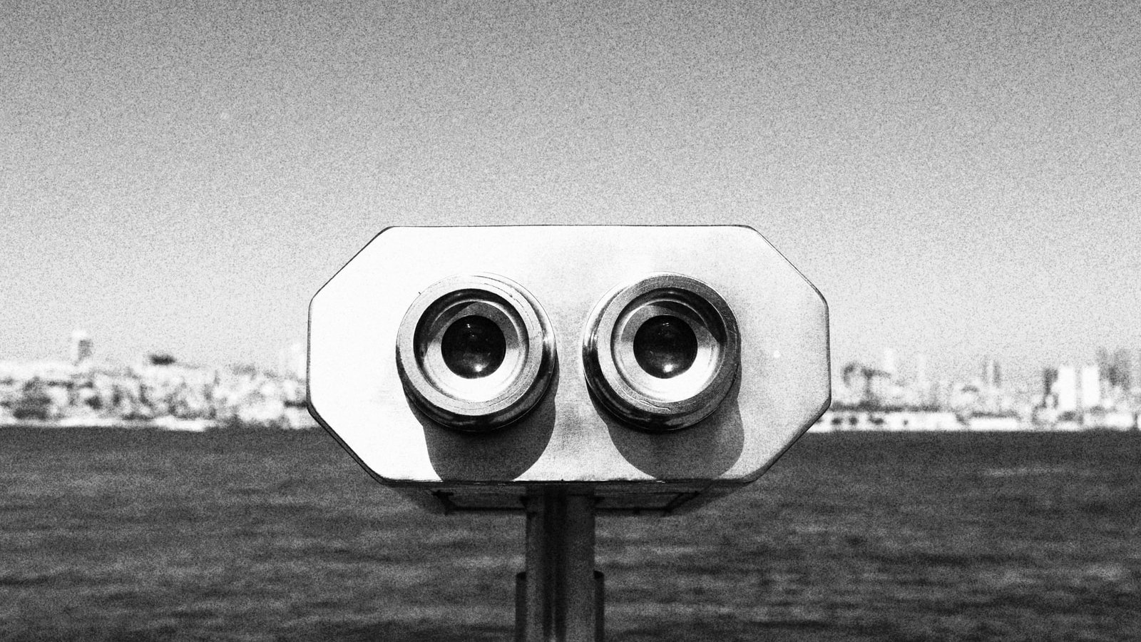 grayscale photo of binoculars on the ground
