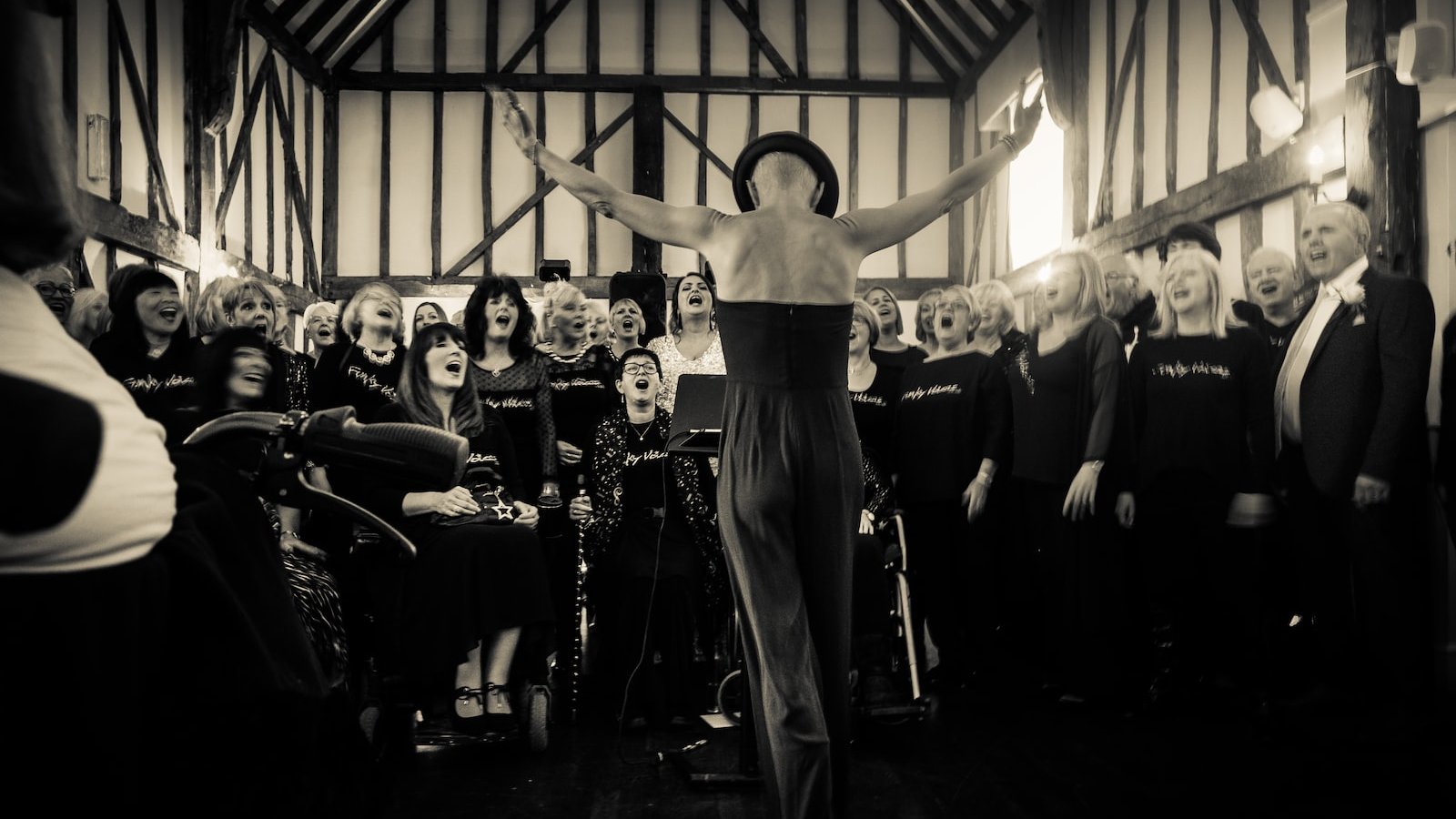 person raising two hands in front of people