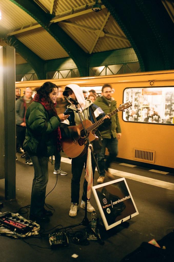 Musicians playing guitar on subway station