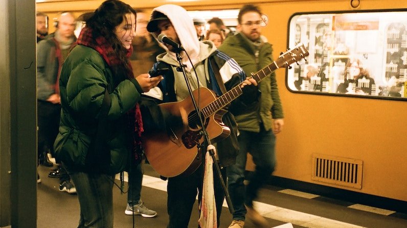 Musicians playing guitar on subway station