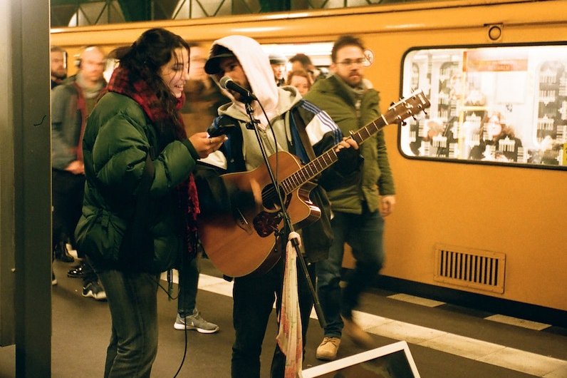 Musicians playing guitar on subway station