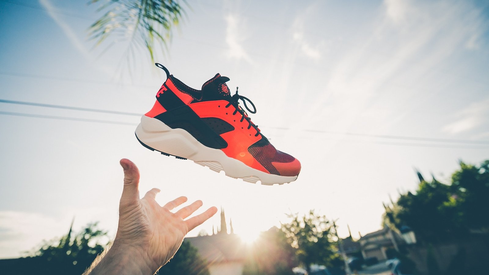 unpaired orange and white Nike Air Huarache