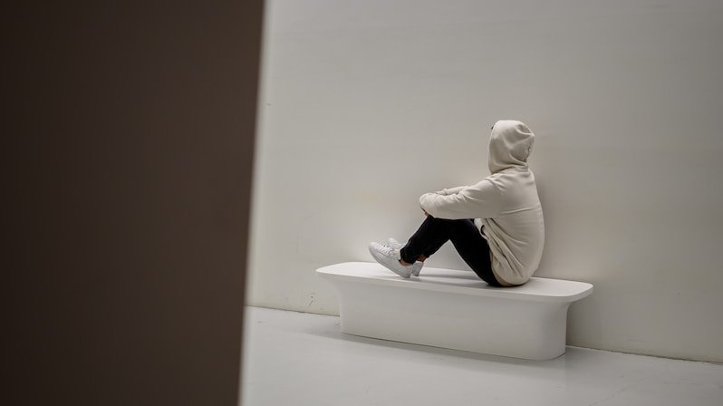 man sitting on white floor