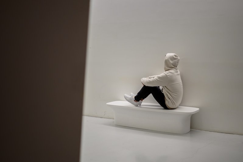 man sitting on white floor