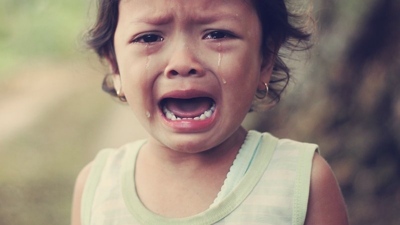 selective focus photography of girl crying