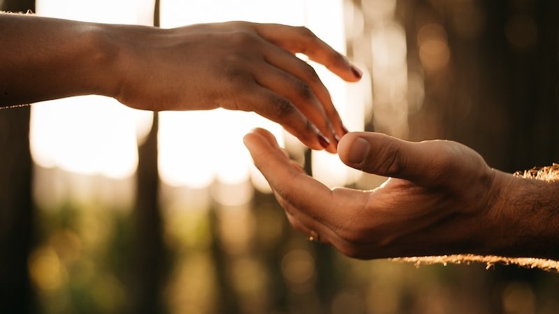 persons hand on white textile