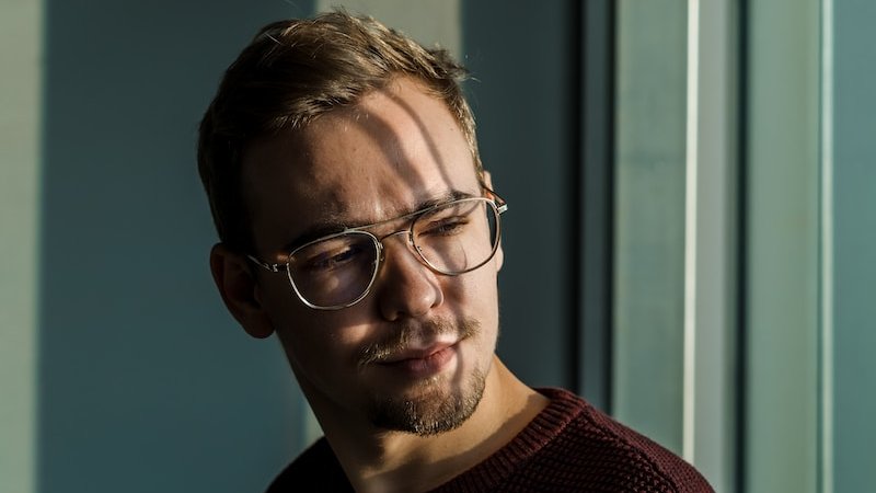 man wearing brown knit crew-neck sweater