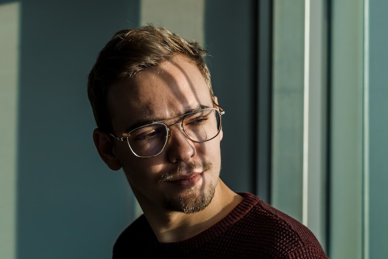 man wearing brown knit crew-neck sweater