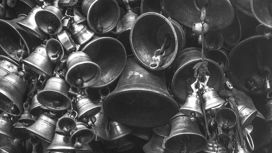 grayscale photo of bells