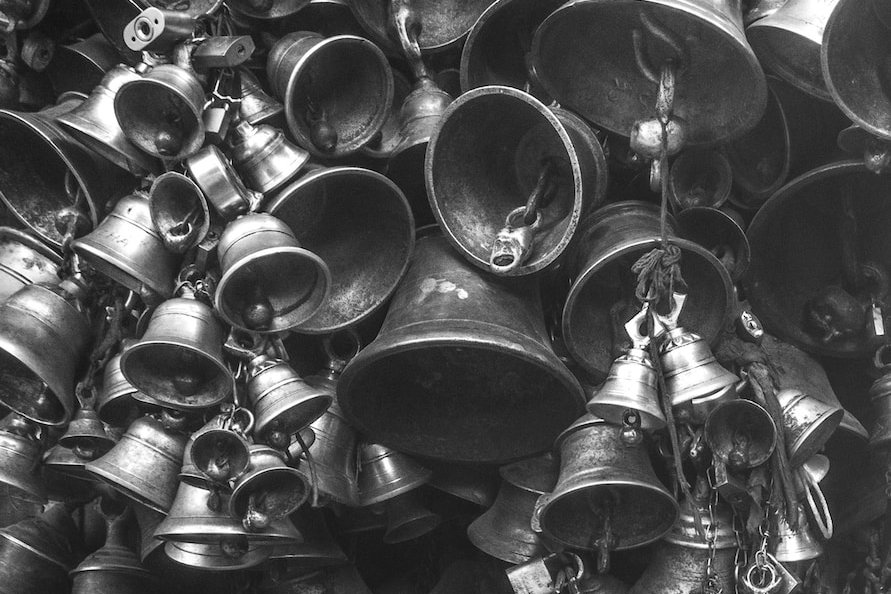 grayscale photo of bells