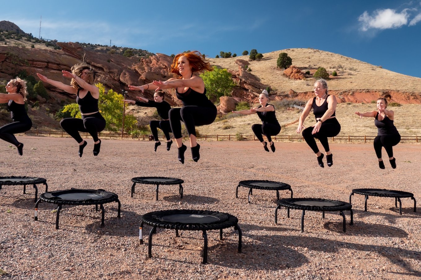 people sitting on black metal chairs on brown rocky mountain during daytime