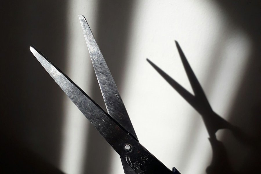 black handle scissors on white surface
