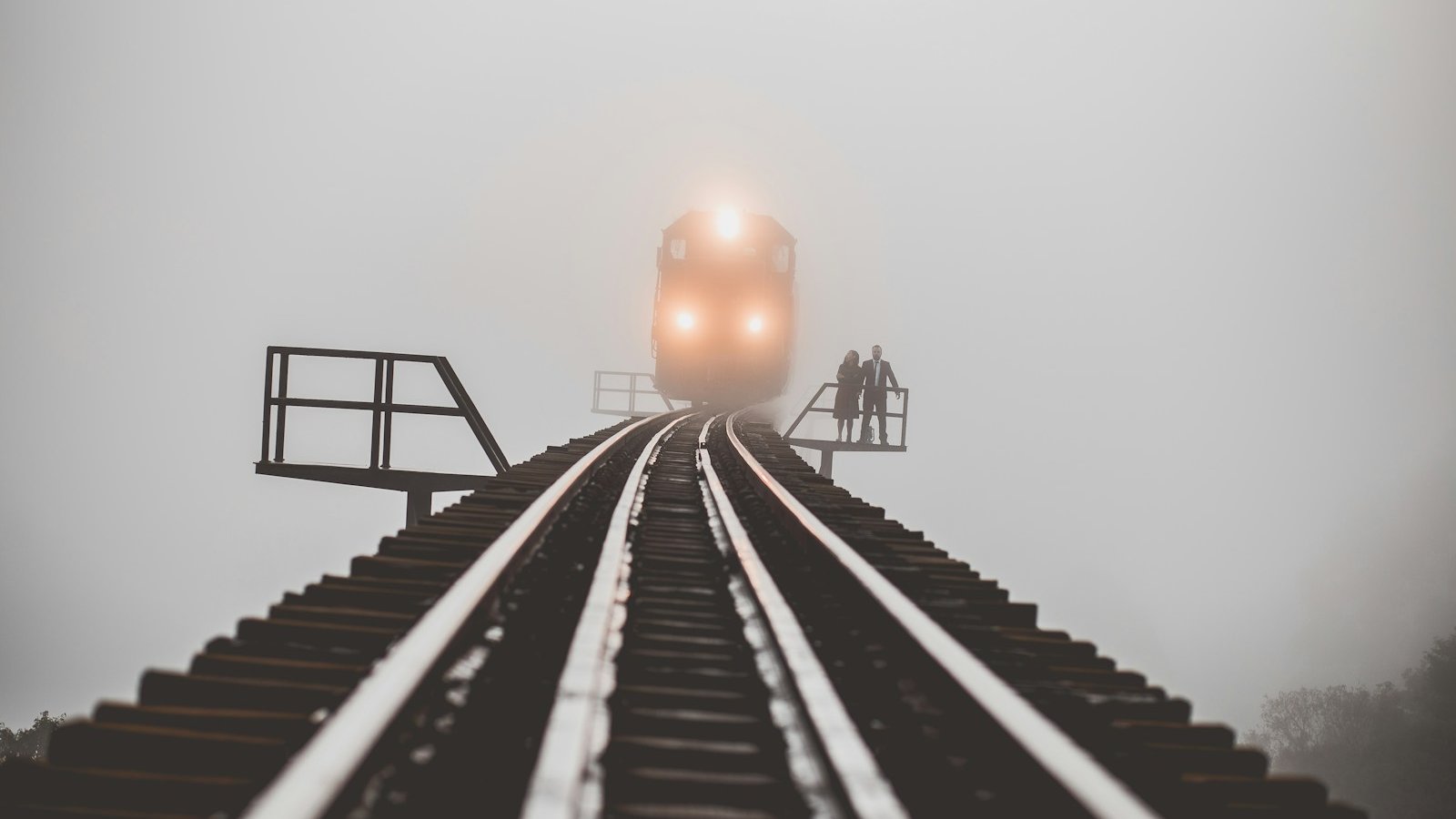 man and woman standing beside trailway