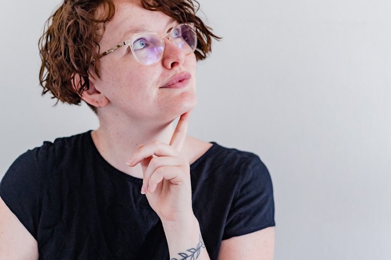 a woman wearing glasses and a black shirt