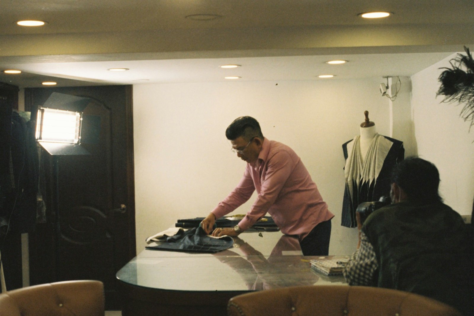 a man ironing clothes on a table in a room