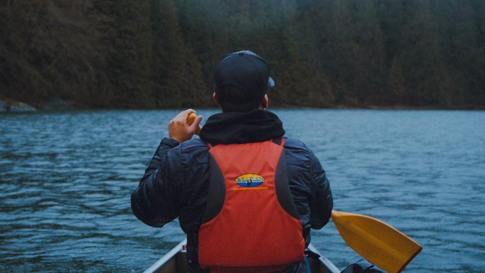 a man in a boat on a body of water