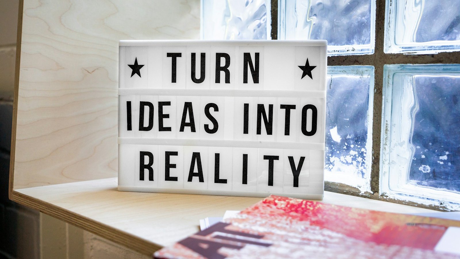 white and black wooden quote board