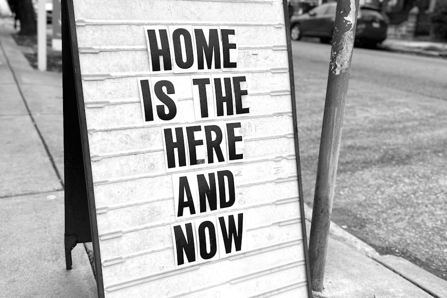a sign on a sidewalk that says home is the here and now
