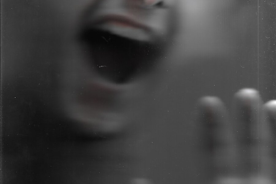 a blurry photo of a person with their mouth open