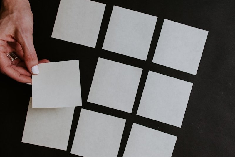 person holding white and black checkered card