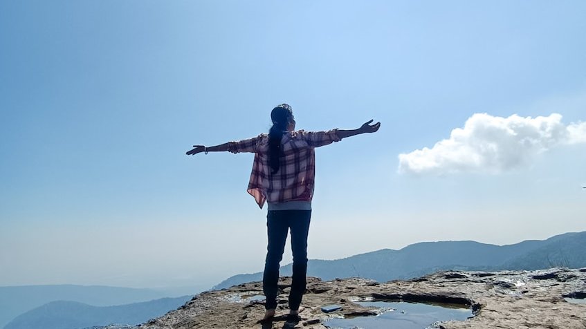a person standing on a rocky beach
