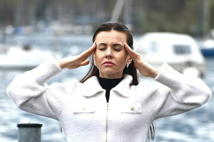 A woman in a white jacket and black skirt