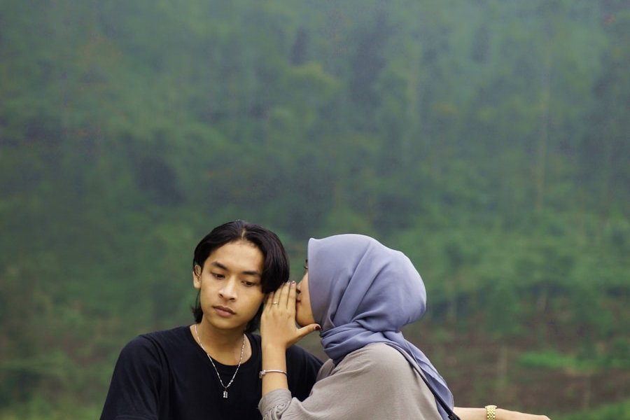 A couple of people sitting on a white bench