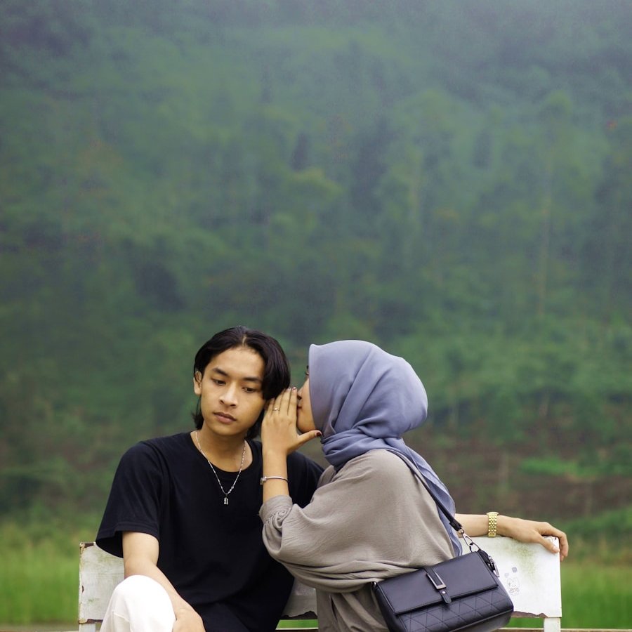 A couple of people sitting on a white bench