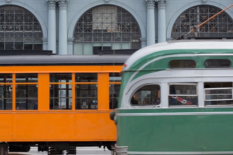 green and yellow train on rail road during daytime