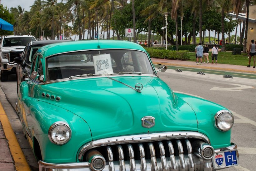 A green car parked on the side of the road