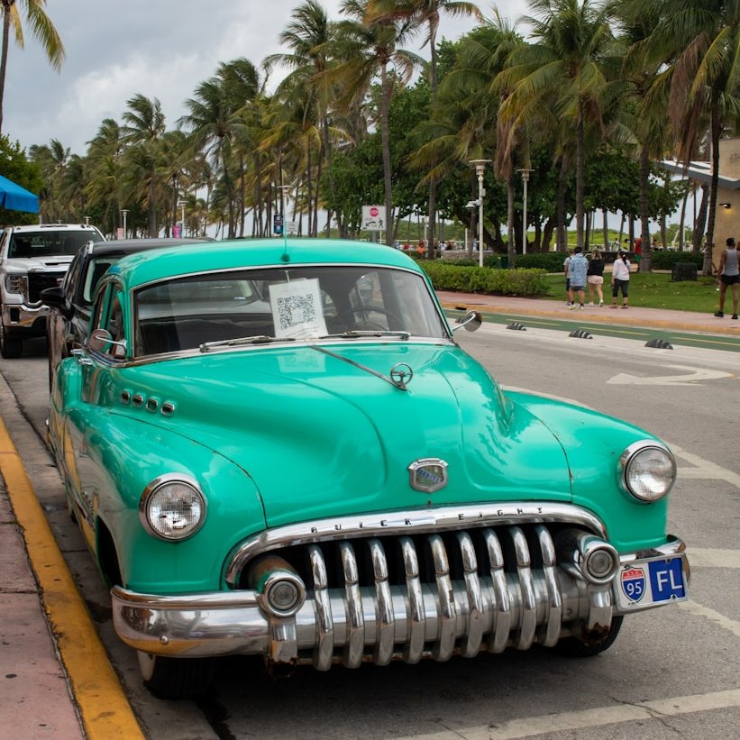 A green car parked on the side of the road